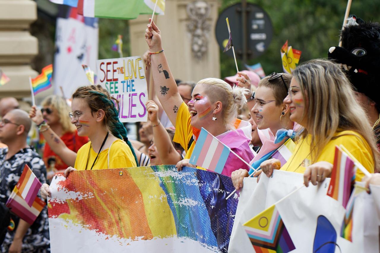 people, ladies, girls, colors, flags, advocacy, event, pride, parade, mark, the street, urban, town, community, cheerfulness, exuberance, claim, rights, physiognomy, snapshot, street photography, chants
